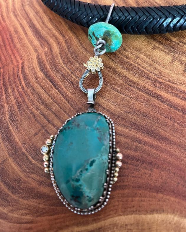 Turquoise pendant in sterling with 14k accents and brown diamond on a leather collar.